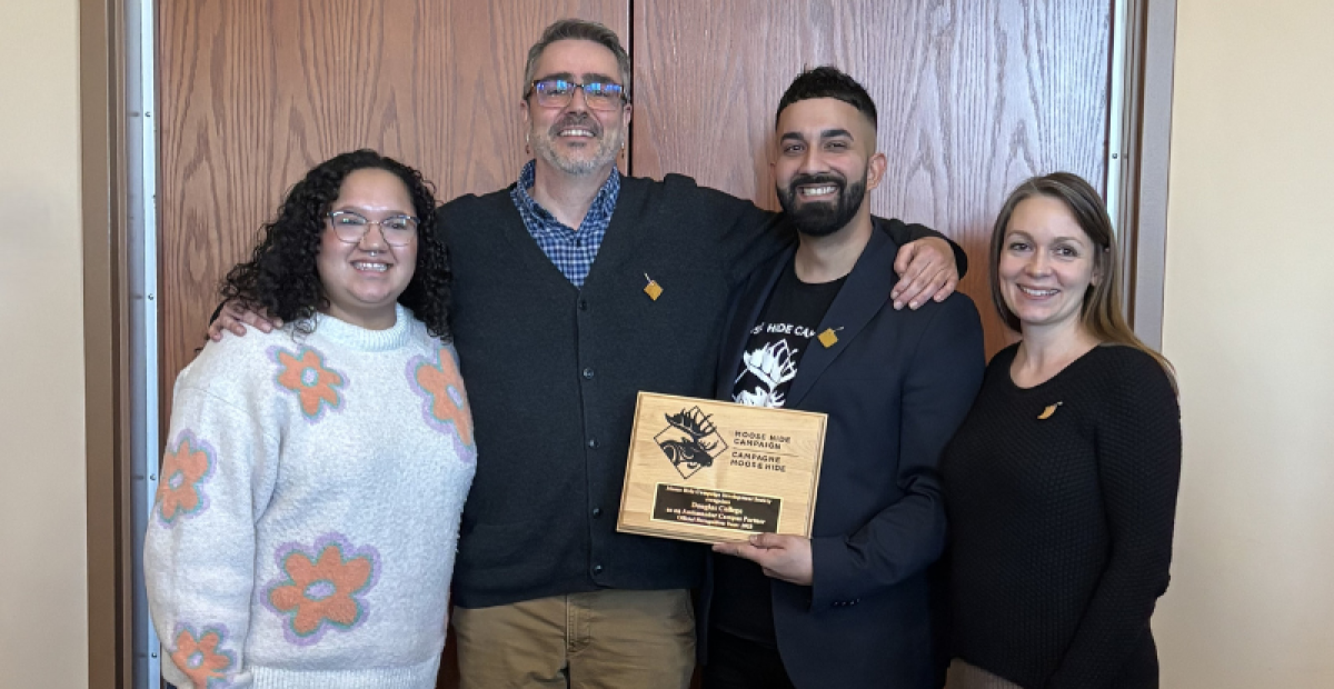 a group of people hold the plaque